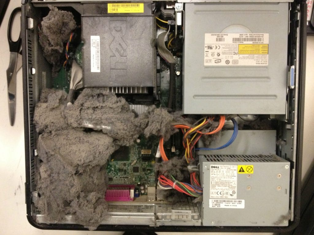 Two dust bunny colonies appear to be vying for dominance within a computer case, further illustrating the need for regular cleaning to prevent such infestations.